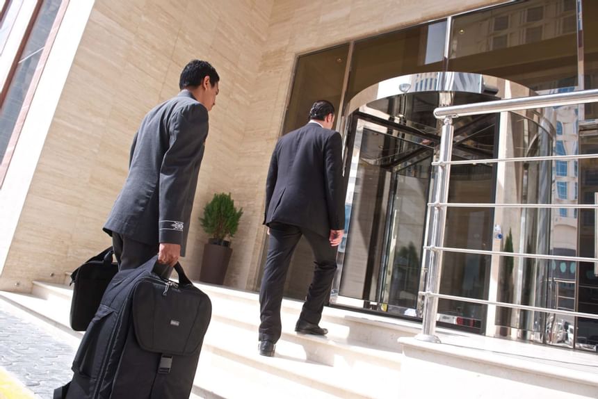Two men walking into hotel entrance at The Royal Riviera Hotel