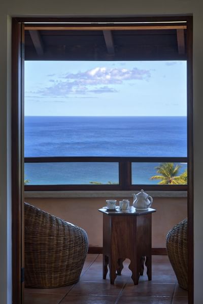 chairs on balcony overlooking ocean