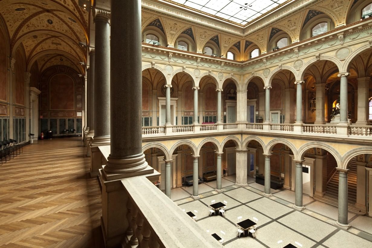 Historic inner courtyard of Vienna’s MAK museum featuring elegant arcades, tall columns, and richly decorated Renaissance style ceilings