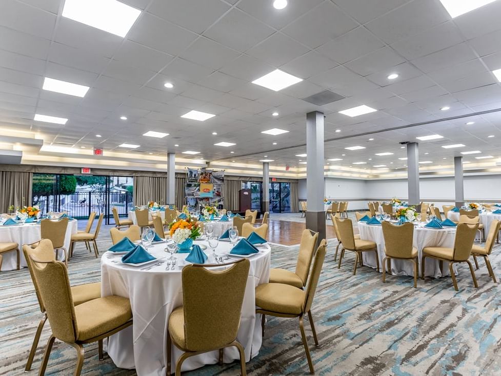 Arranged banquet tables in The Riviera Room at Anaheim Hotel