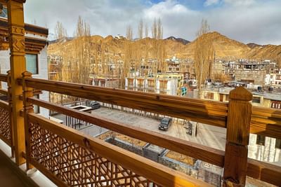Balcony overlooking the mountains & buildings from Grande Suite at The Indus Valley Leh, stay in Ladakh