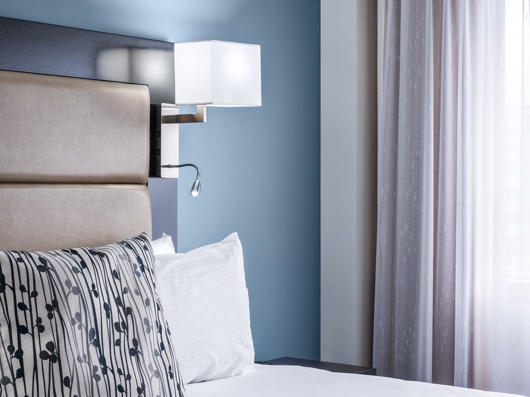room with bed and wall lamp