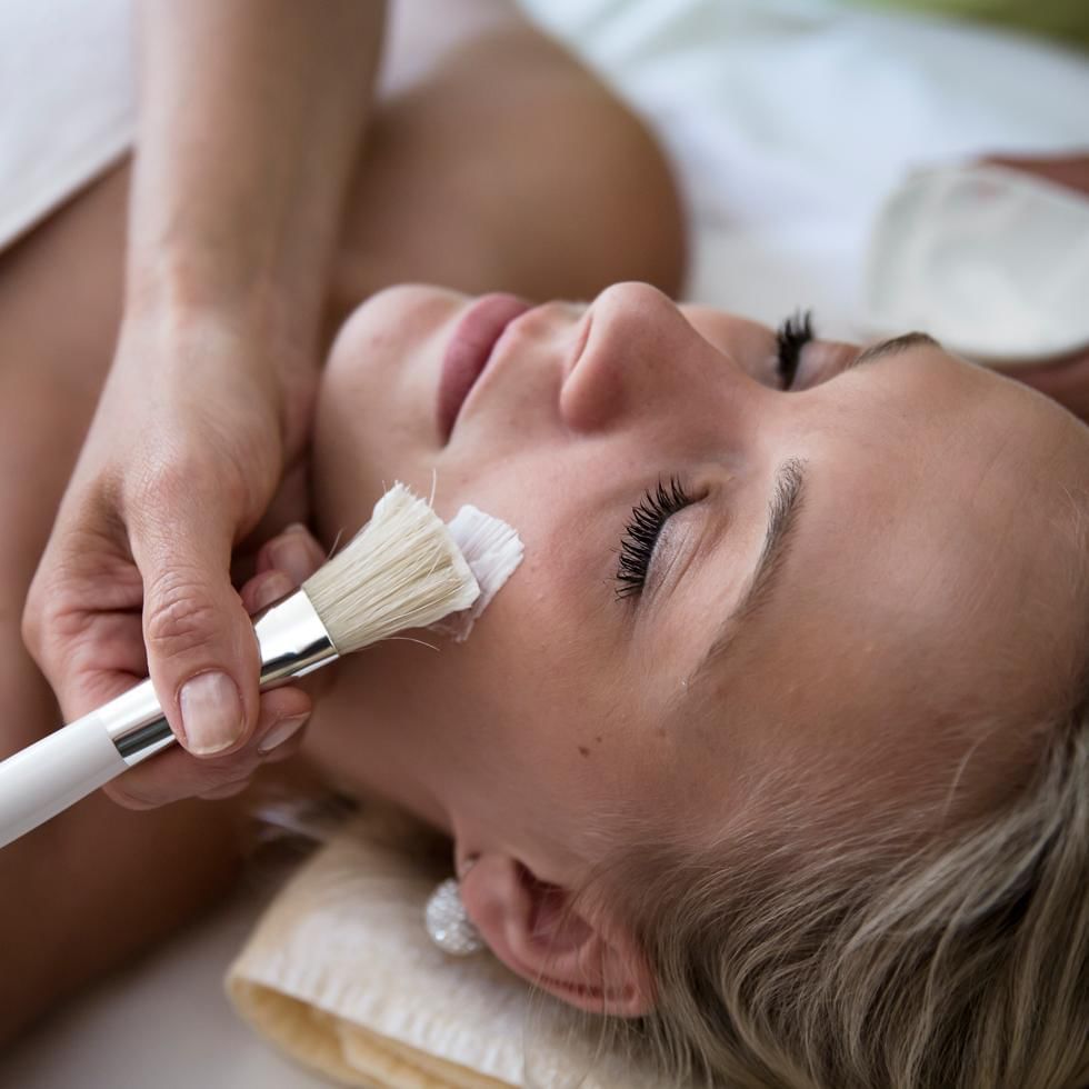 Close-up of applying facial on a woman at Falkensteiner Hotels