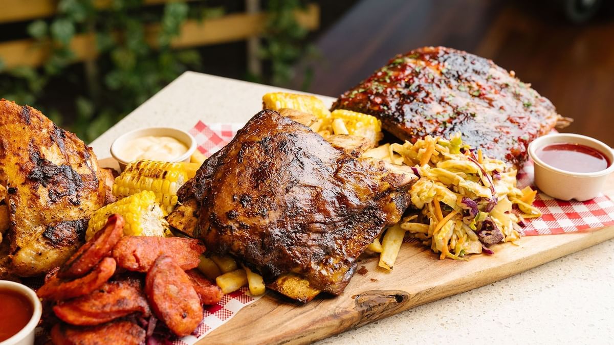 BBQ ribs with corn, coleslaw, fries & sauce in a restaurant at Crown Hotels