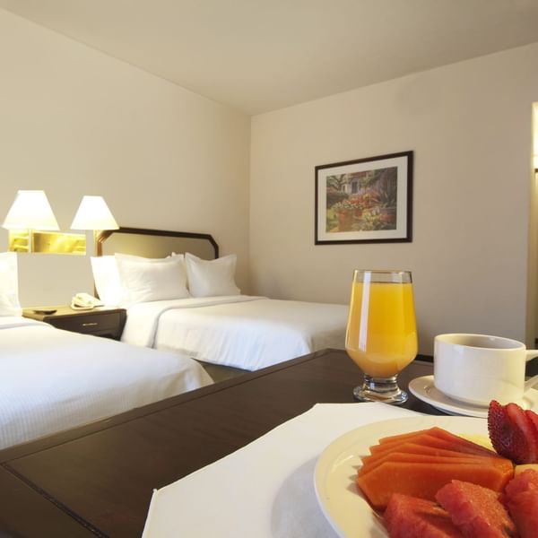 Close up on a plate of cut fruits served in room at Fiesta Inn