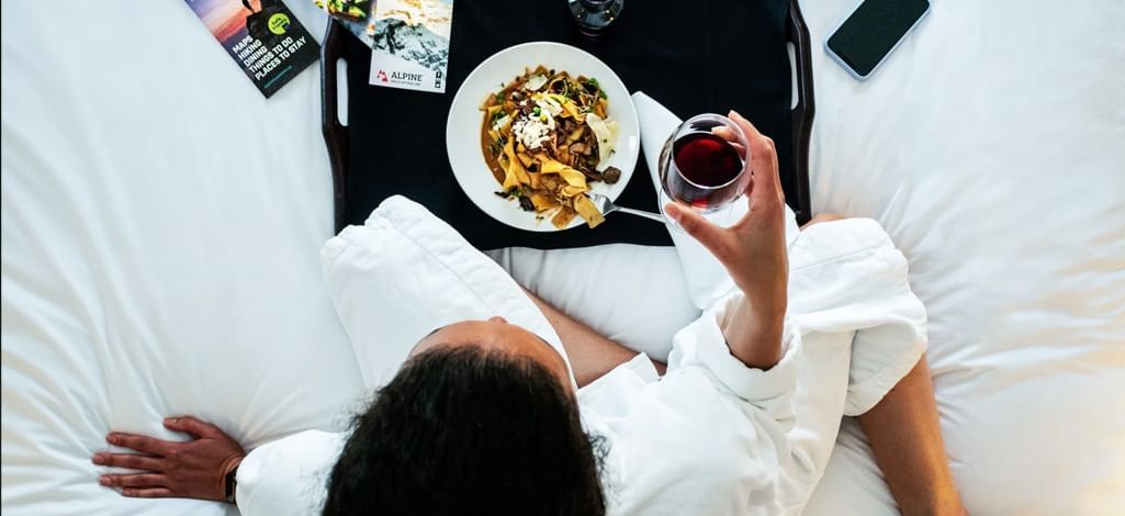 a person having pasta and wine