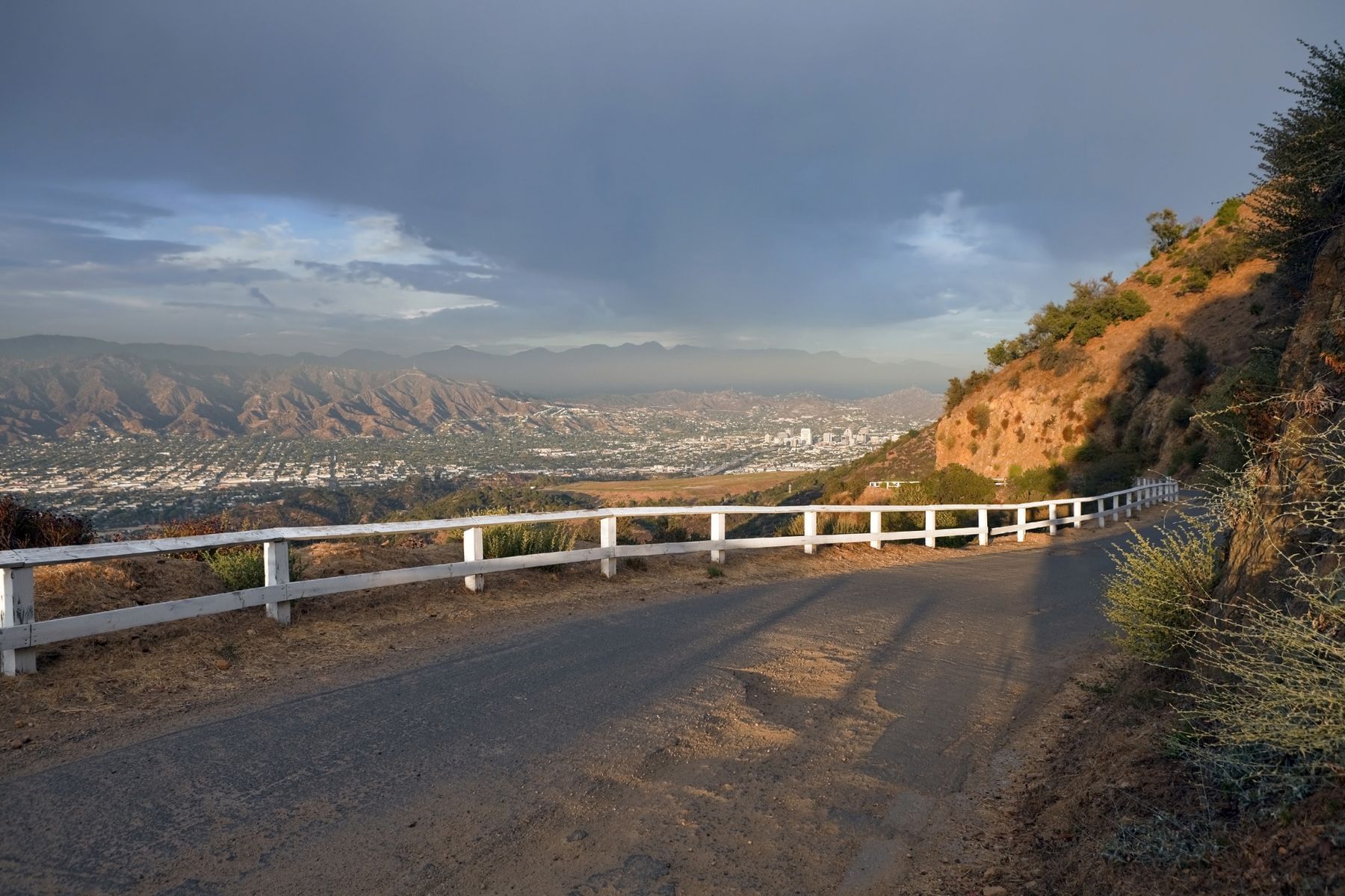 Dirt road with view of valley and mountains