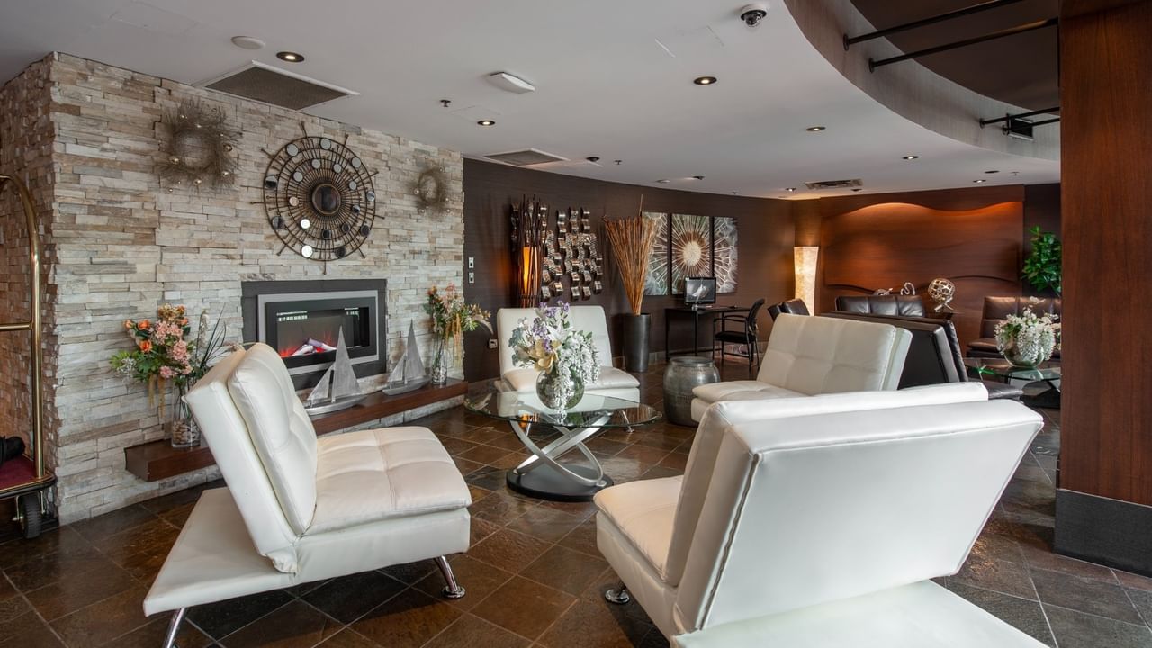 Seating area with chairs by the hotel lobby fireplace