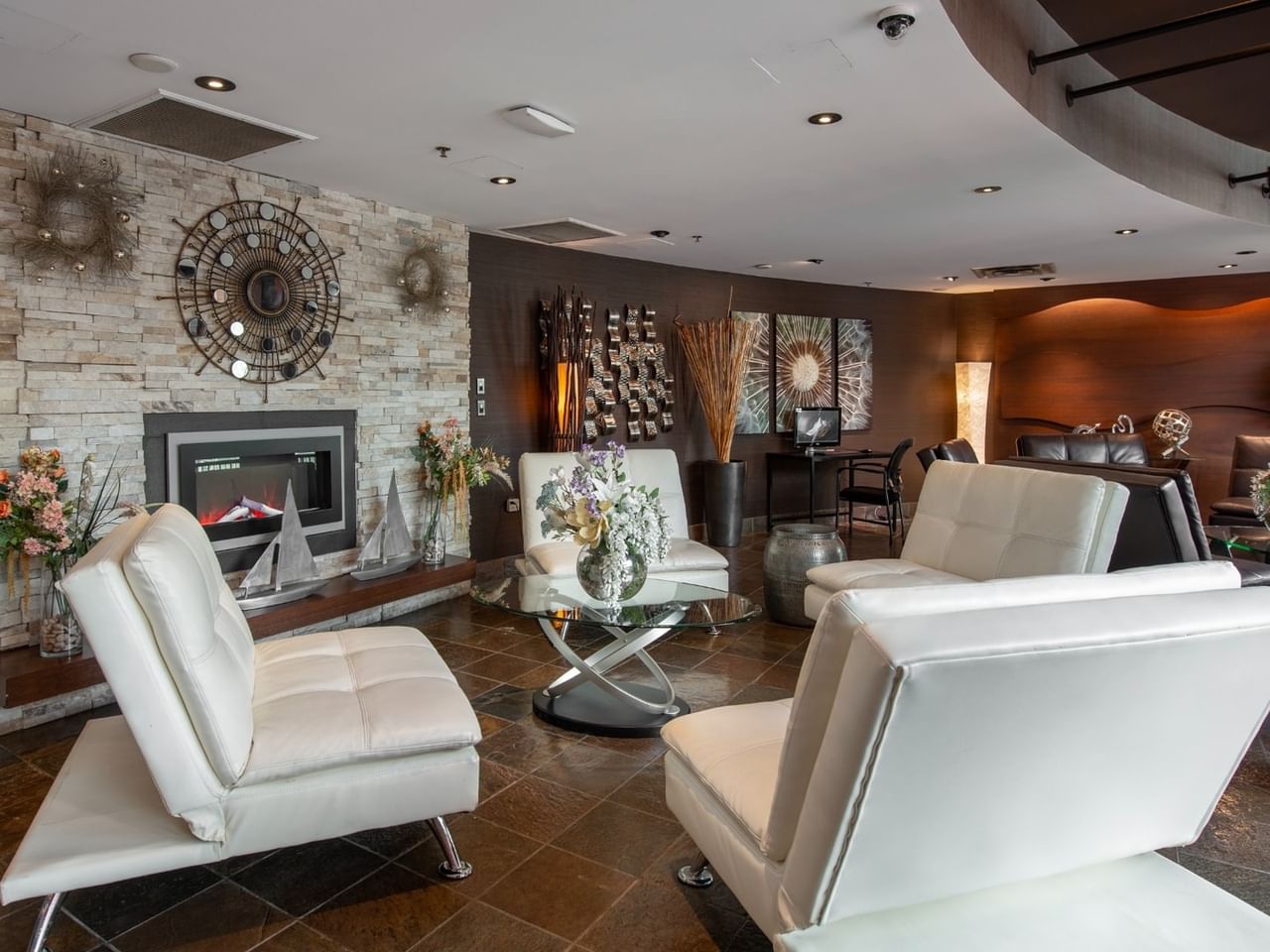 Seating area with chairs by the hotel lobby fireplace
