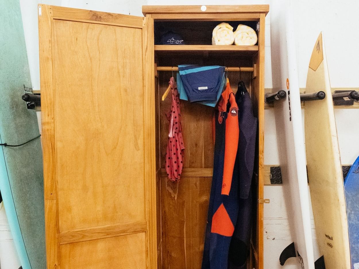 Surfing boards near a cupboard at The Rockaway Hotel
