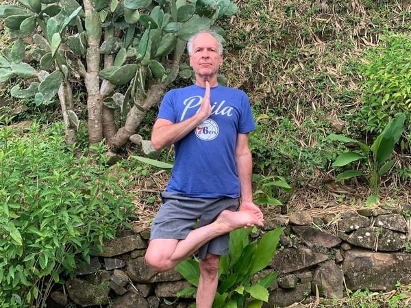 Old man doing yoga in garden at Retreat Costa Rica