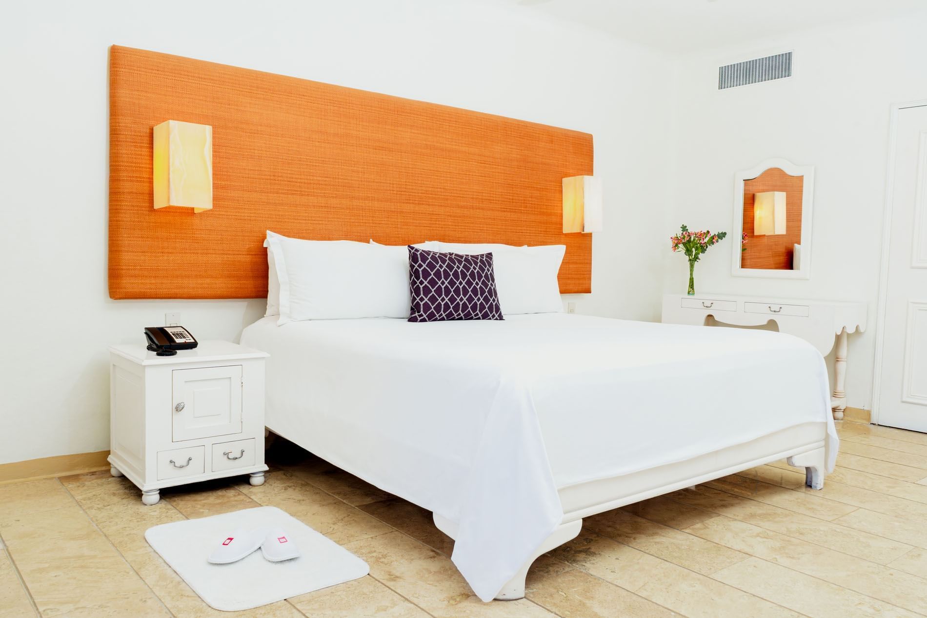 Nightstand and dresser by the cozy bed in King Suite Private Pool with wooden floors at Camino Real Zaashila Huatulco
