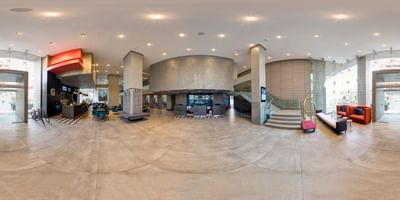 Panoramic lobby view featuring a reception desk and seating area, highlighting one of the best Chile hotels at Veranda Hotel