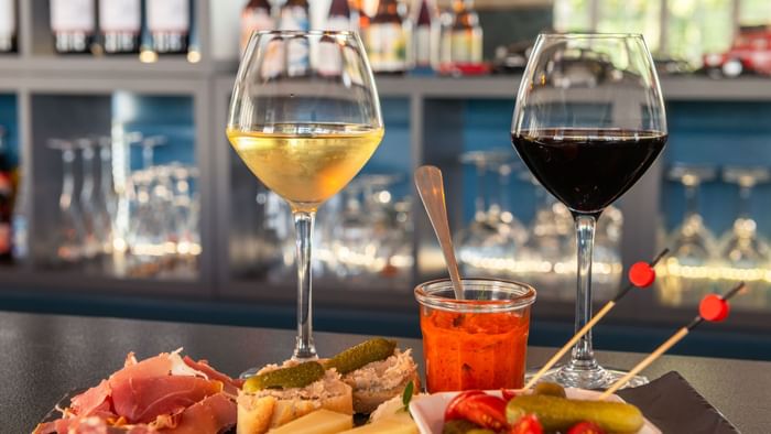 Closeup of tapas and wine served in a bar at Originals Hotels