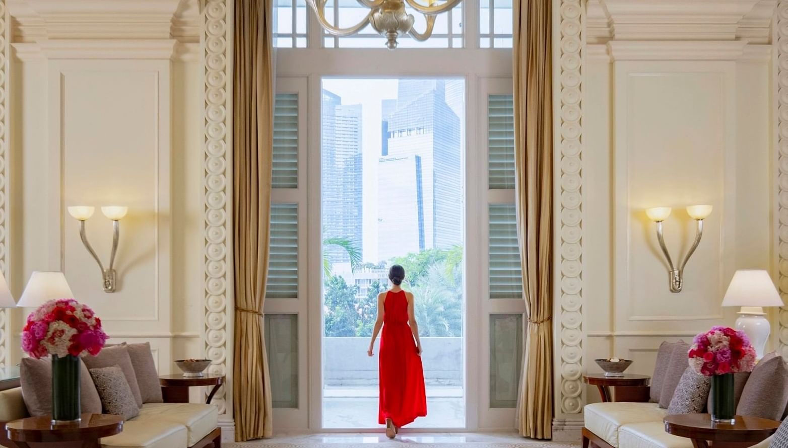 A lady red posing at the main entrance of Fullerton Singapore