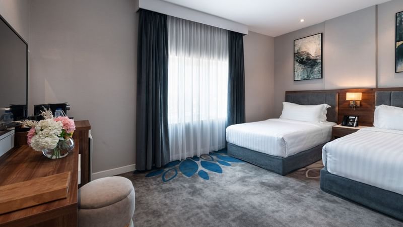 Two beds with nightstand in Family Suite Sea View at Warwick Hotels & Resorts