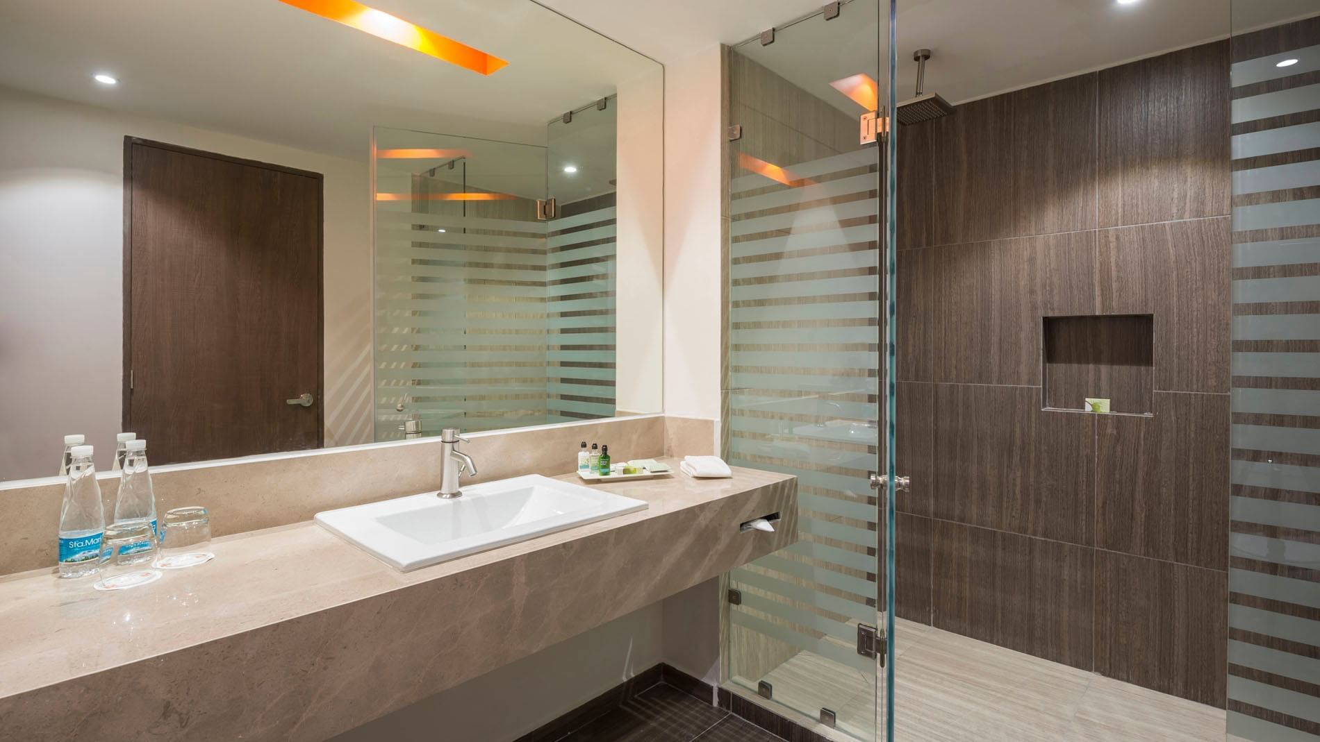 King Superior bathroom featuring a marble vanity, large mirror, and a glass-enclosed walk-in shower at Real Inn Celaya