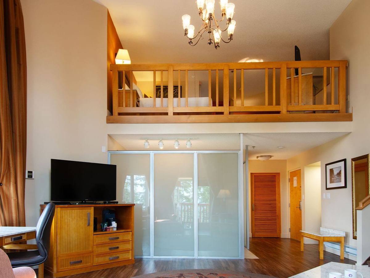 Loft suite with large living area and a bedroom on the second floor