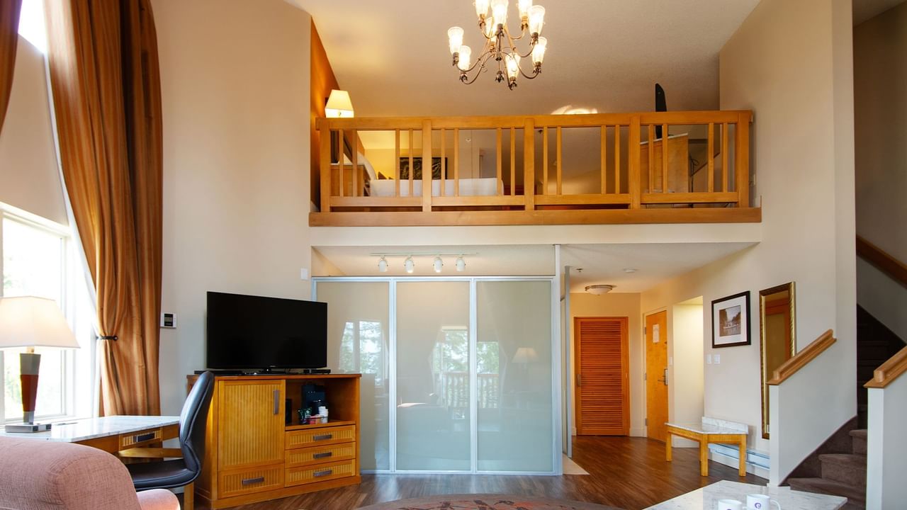 Loft suite with large living area and a bedroom on the second floor