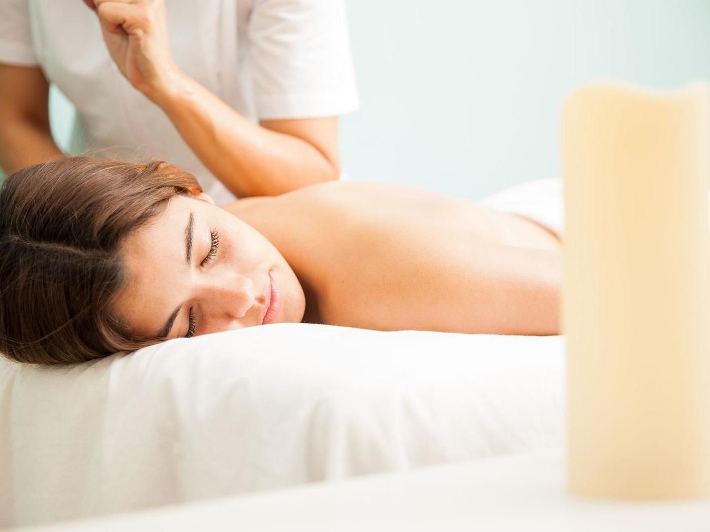 A woman getting a massage in a spa at FA Hotels & Resorts