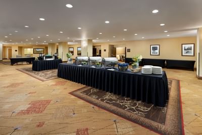A banquet hall with multiple tables set up for an event at Elevation Resort and Spa.