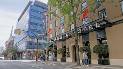 Exterior view of The St. Regis Hotel, a boutique hotel in Vancouver, with a bustling street