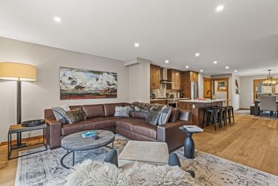 Luxury living room with sofa and open kitchen in 32 Tamarack Streamside Villas Four Bedroom Townhouse at Spring Creek Vacation