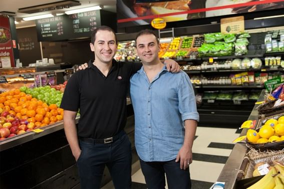 Two men posing in IGA Portside supermarket near Alcyone Hotel Residences