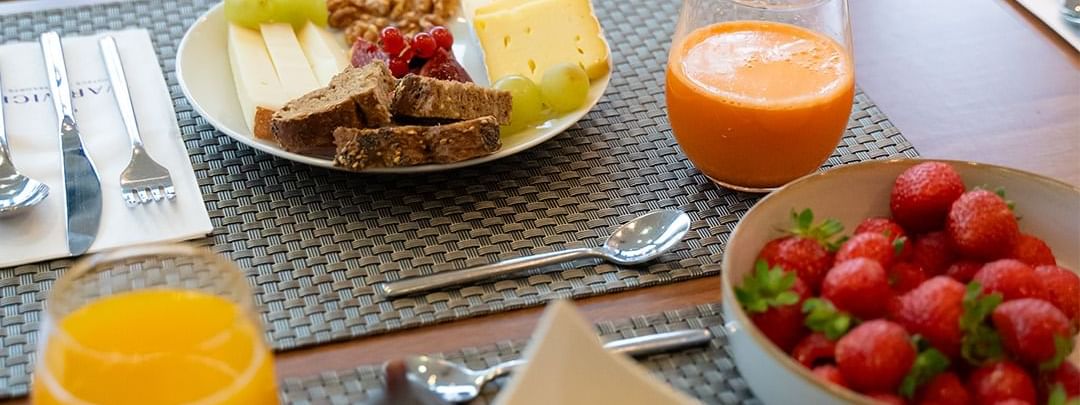Delightful and fresh fruit and cheese plate for breakfast at Warwick Hotels and Resorts, with orange juice