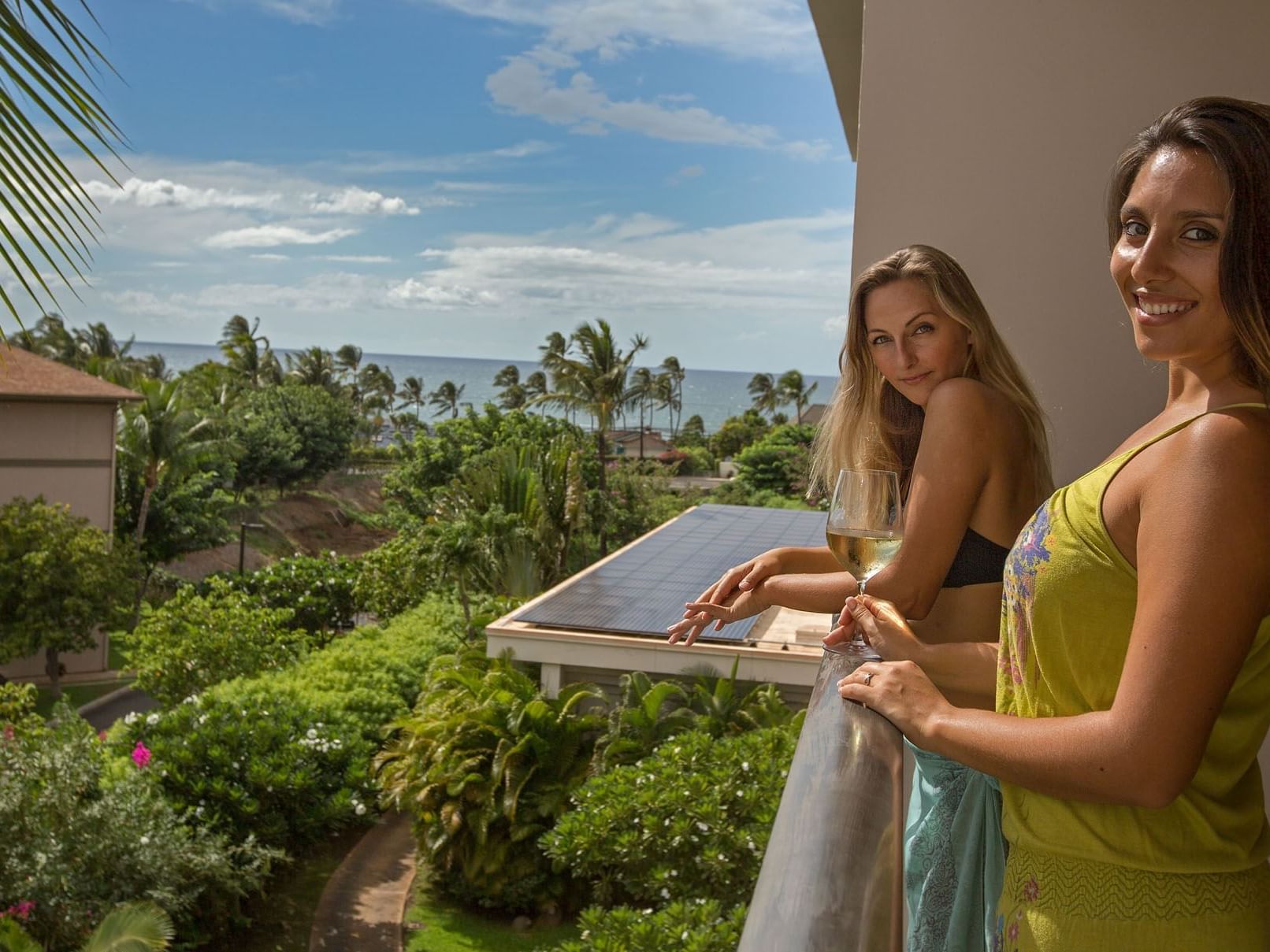 2 ladies posing on a balcony with sea view at Maui Coast Hotel