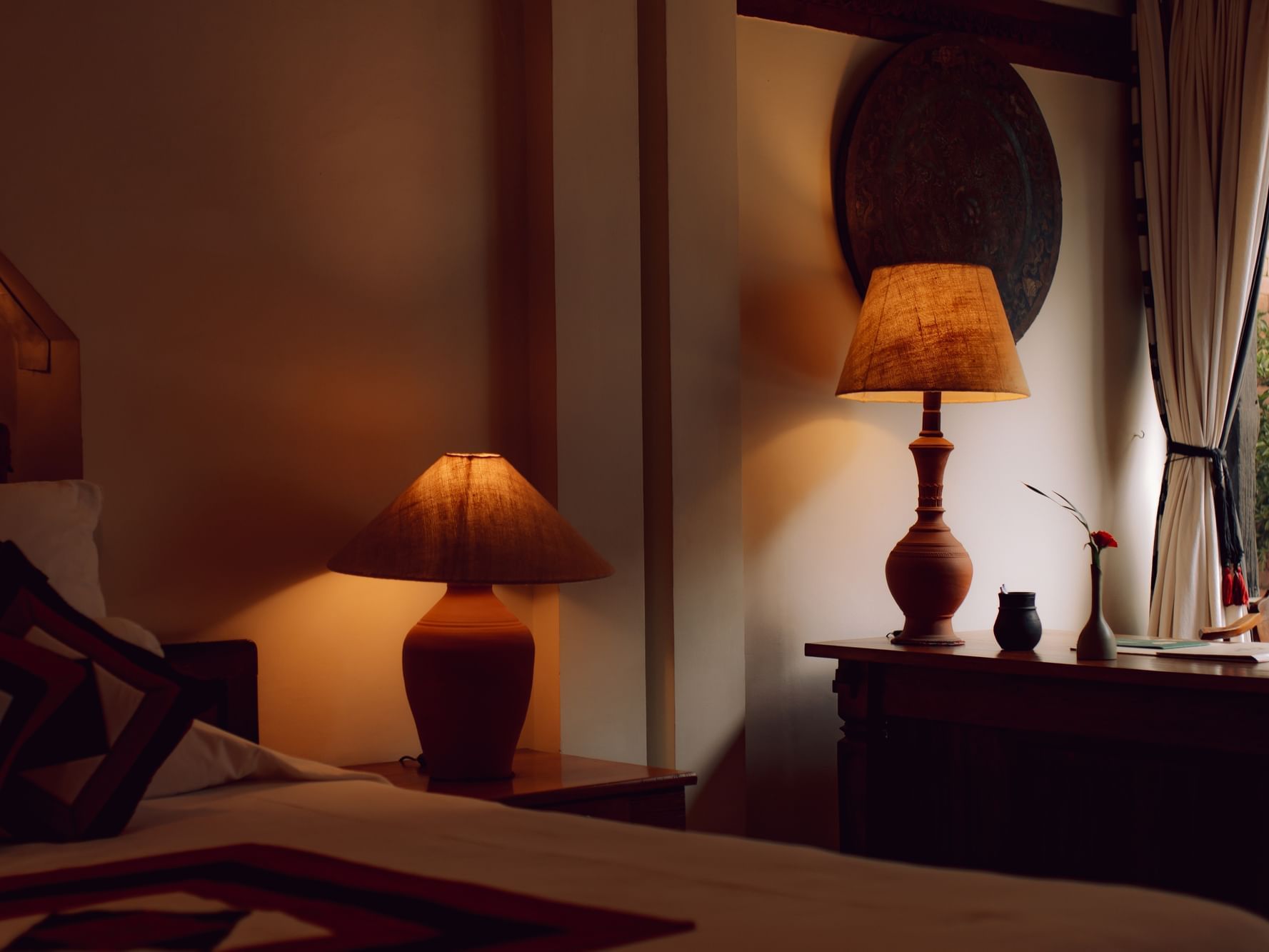 Bedside lamp on a nightstand in Executive Suite with a warm ambience at Dwarika's Hotel Kathmandu