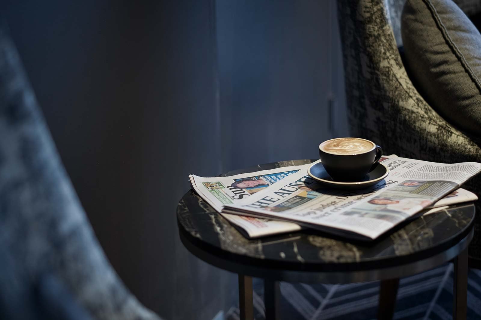 coffee & newspaper on side table at Pullman Melbourne on the park