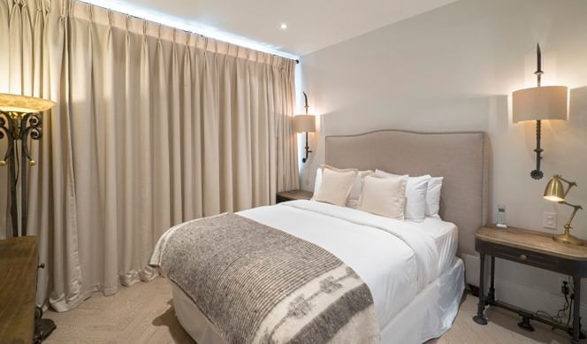 Queen bed with cushioned headboard in The Jean-Talon Room at Hotel Port Royal