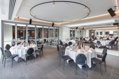 Banquet tables arranged for an event at Amora Hotel Melbourne
