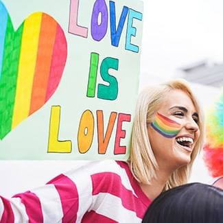 Girl holding a Love is Love sign