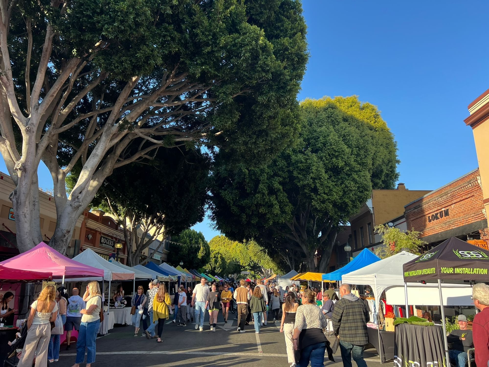 San Luis Obispo Farmers Market with tents and people walking around