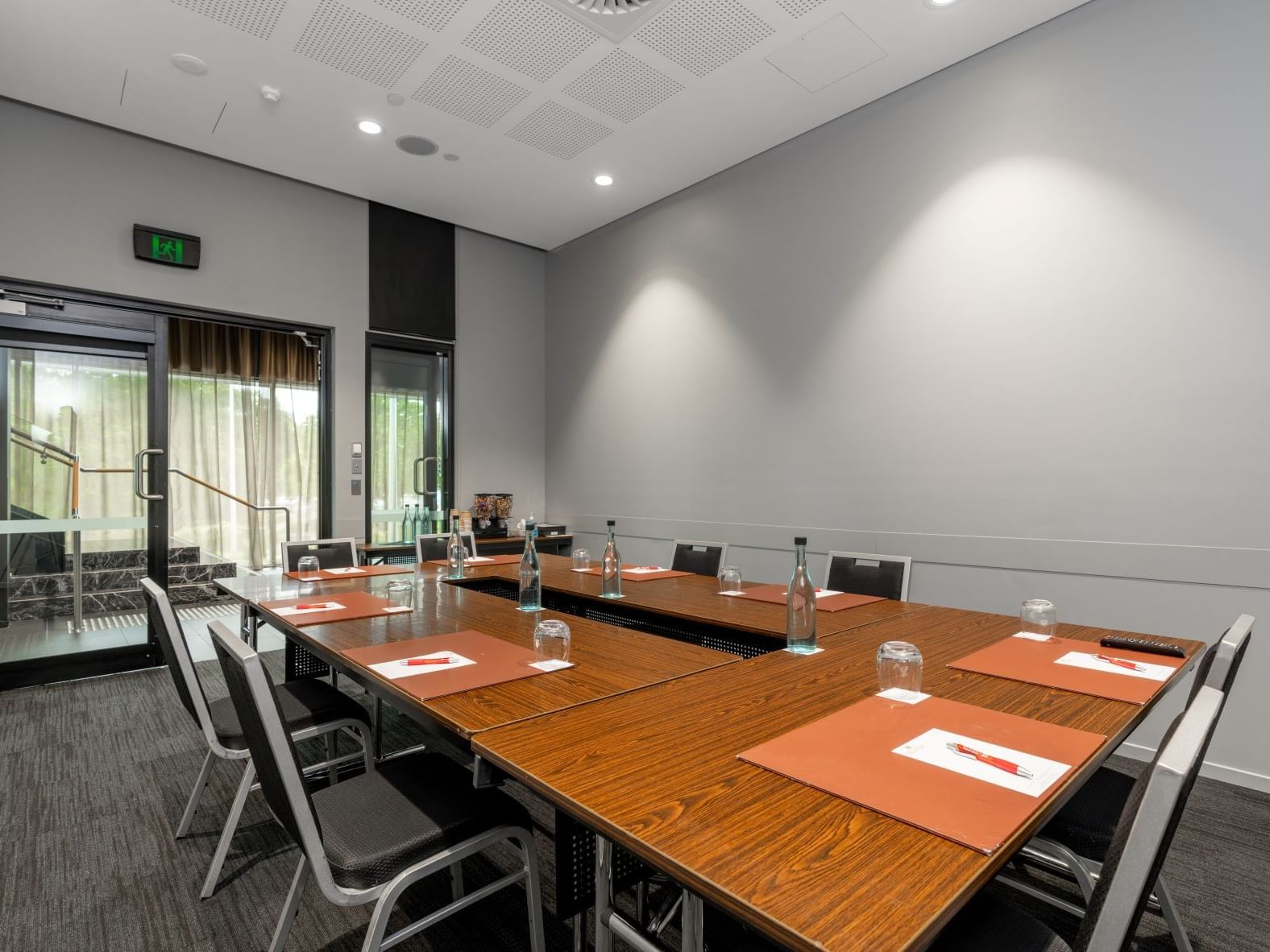 Executive boardroom meeting space in Brisbane with U-shape table setup and modern conference facilities at Hotel Grand Chancellor Brisbane.