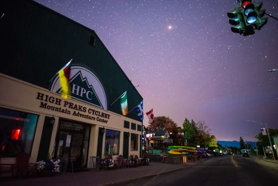 High Peaks Cyclery Mountain Adventures center by a street under a starry night sky near High Peaks Resort