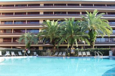 Exterior view of outdoor pool & hotel building at Rosen Inn at Pointe Orlando