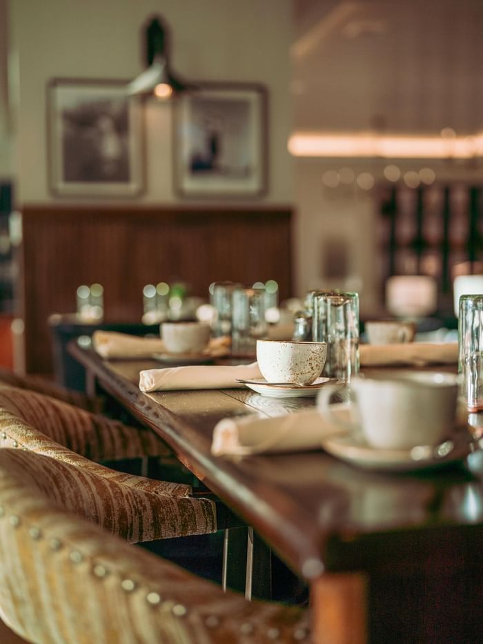 Dining table with set place settings and glasses at 1936 restaurant near Watersound Inn, Inlet Beach.