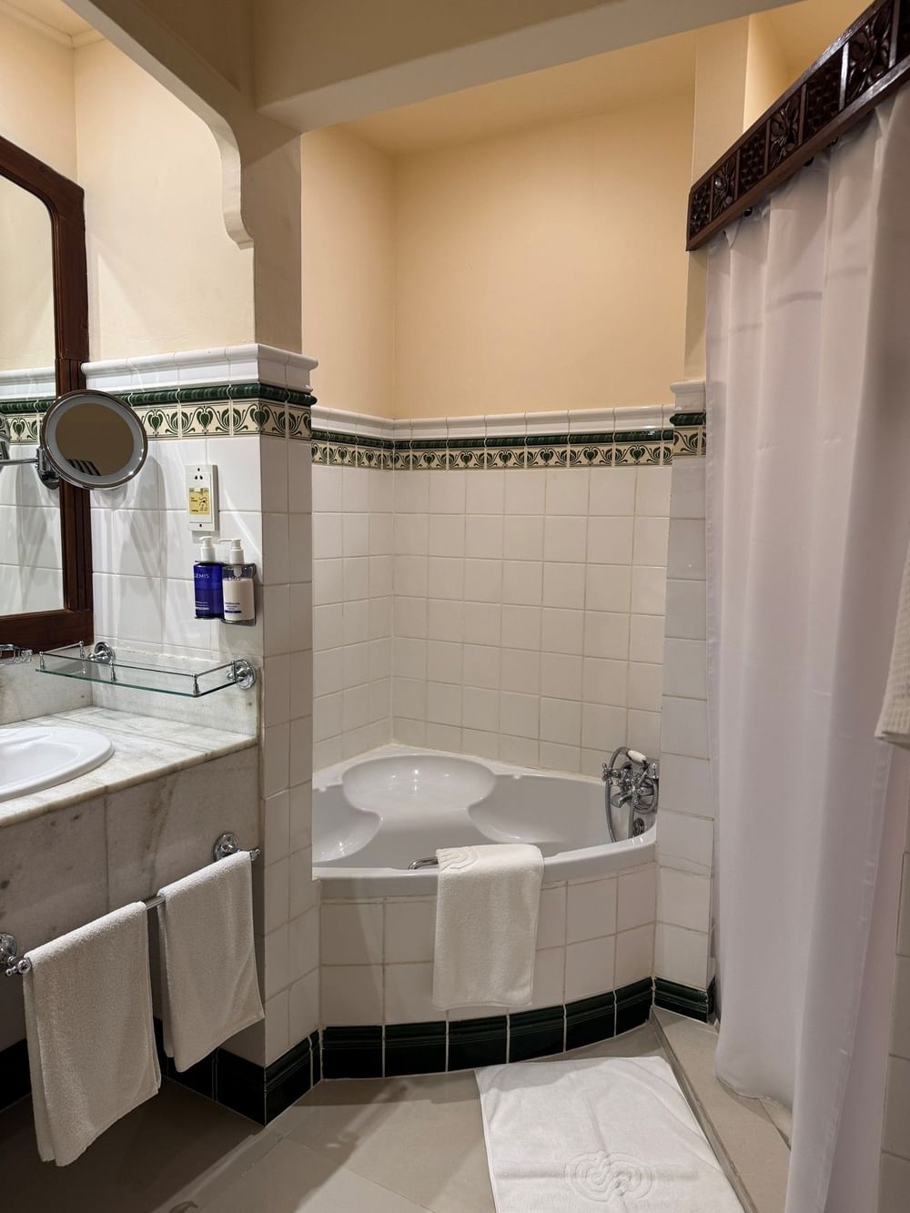 Standard Triple Room bathroom with bathtub and towels at Zanzibar Serena Hotel, Zanzibar.