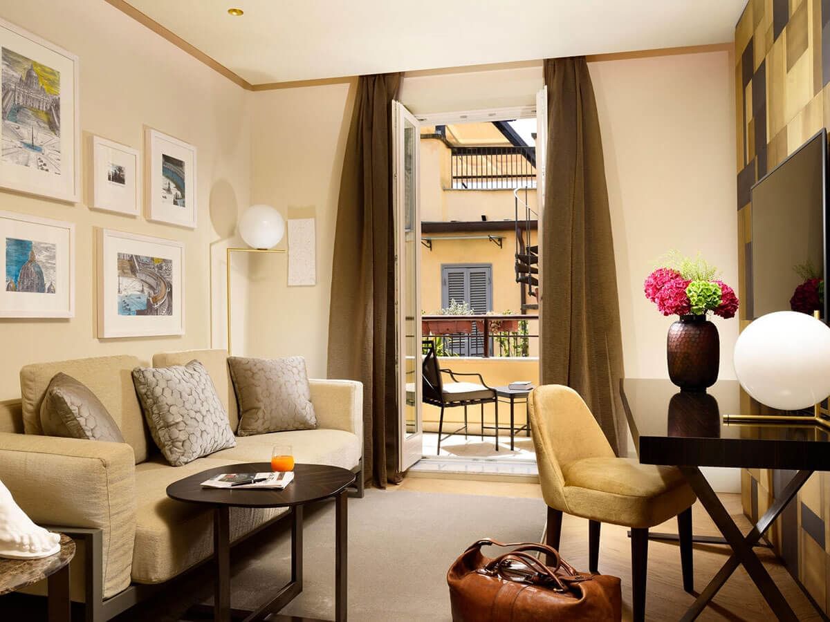 Living area with balcony in Deluxe Suite at Rome Luxury Suites