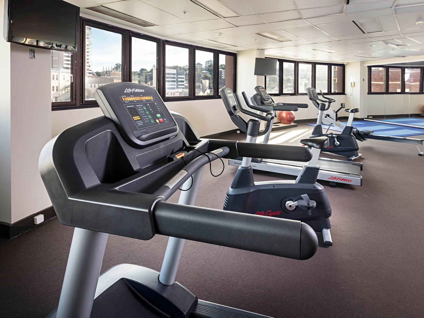 Exercise machines in the Gym overlooking the city at Hotel Grand Chancellor Townsville
