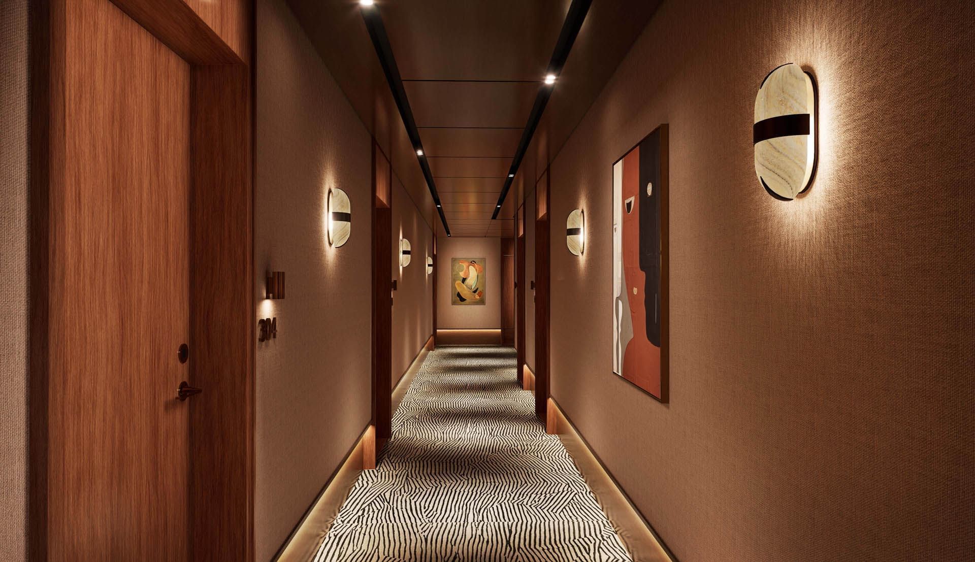 Elegant corridor at Thompson Rome by Hyatt with warm lighting, art-lined walls, and patterned carpet