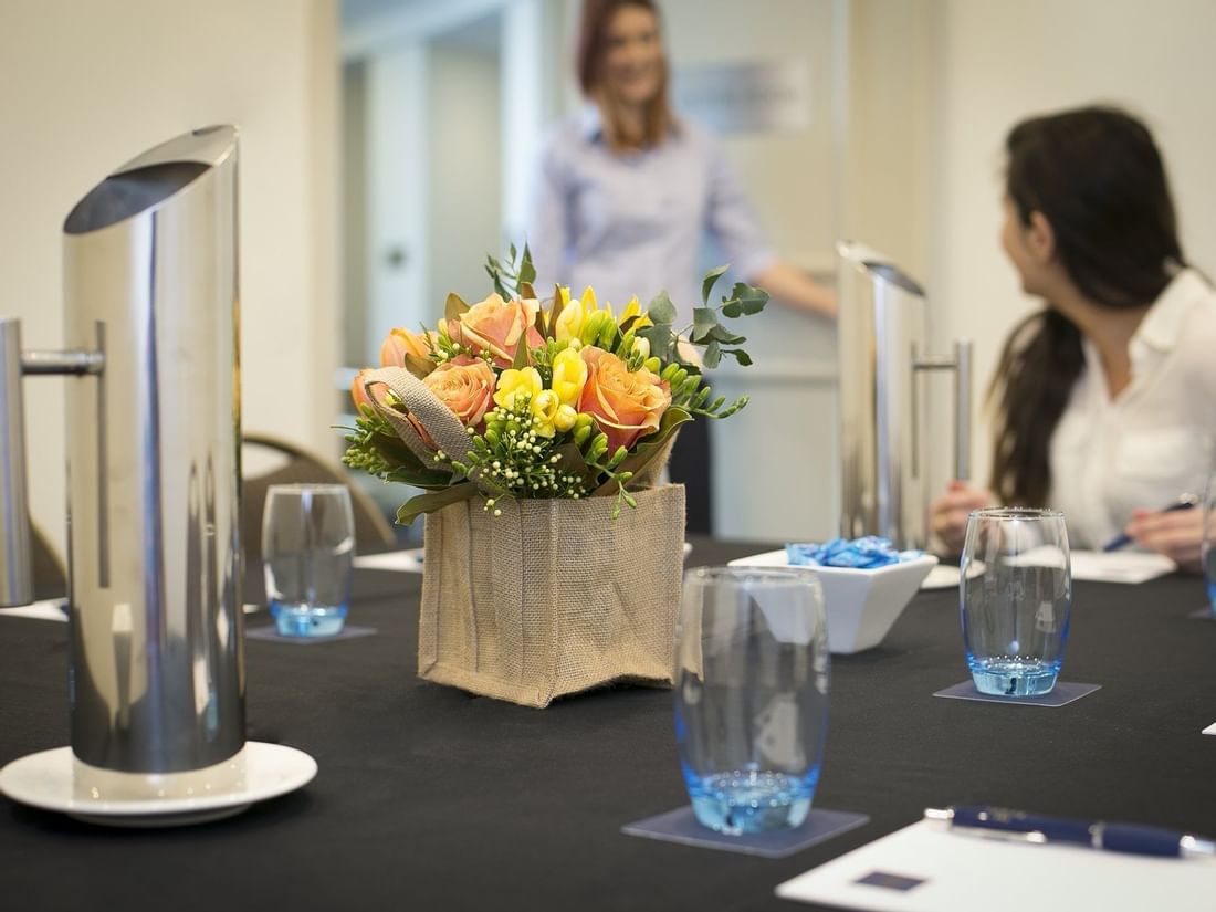 Two ladies discussing in the meeting room at the Sebel Residence Chatswood