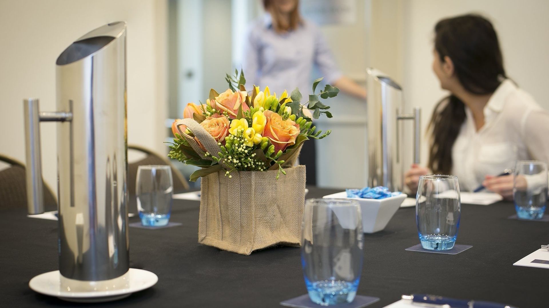 Two ladies discussing in the meeting room at the Sebel Residence Chatswood