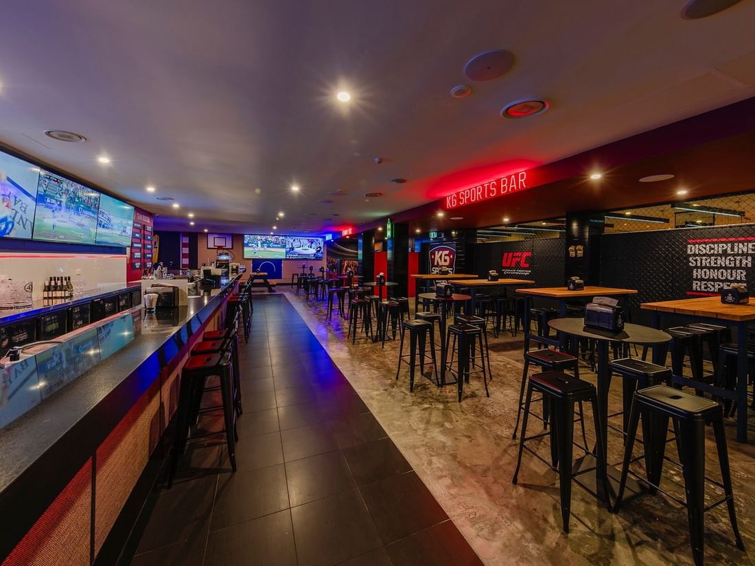 View of the KG Sport Bar lounge with multiple screens and seating areas at Mercure Brisbane King George Square