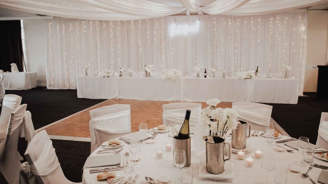 Elegant interior of a wedding reception area with table set up at Mercure Kooindah Waters