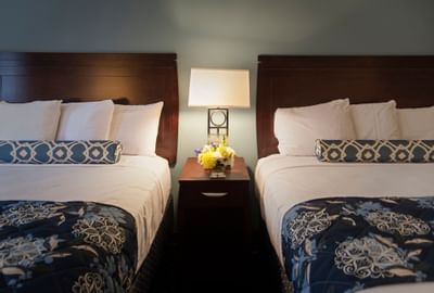 guest room with two beds and nightstand