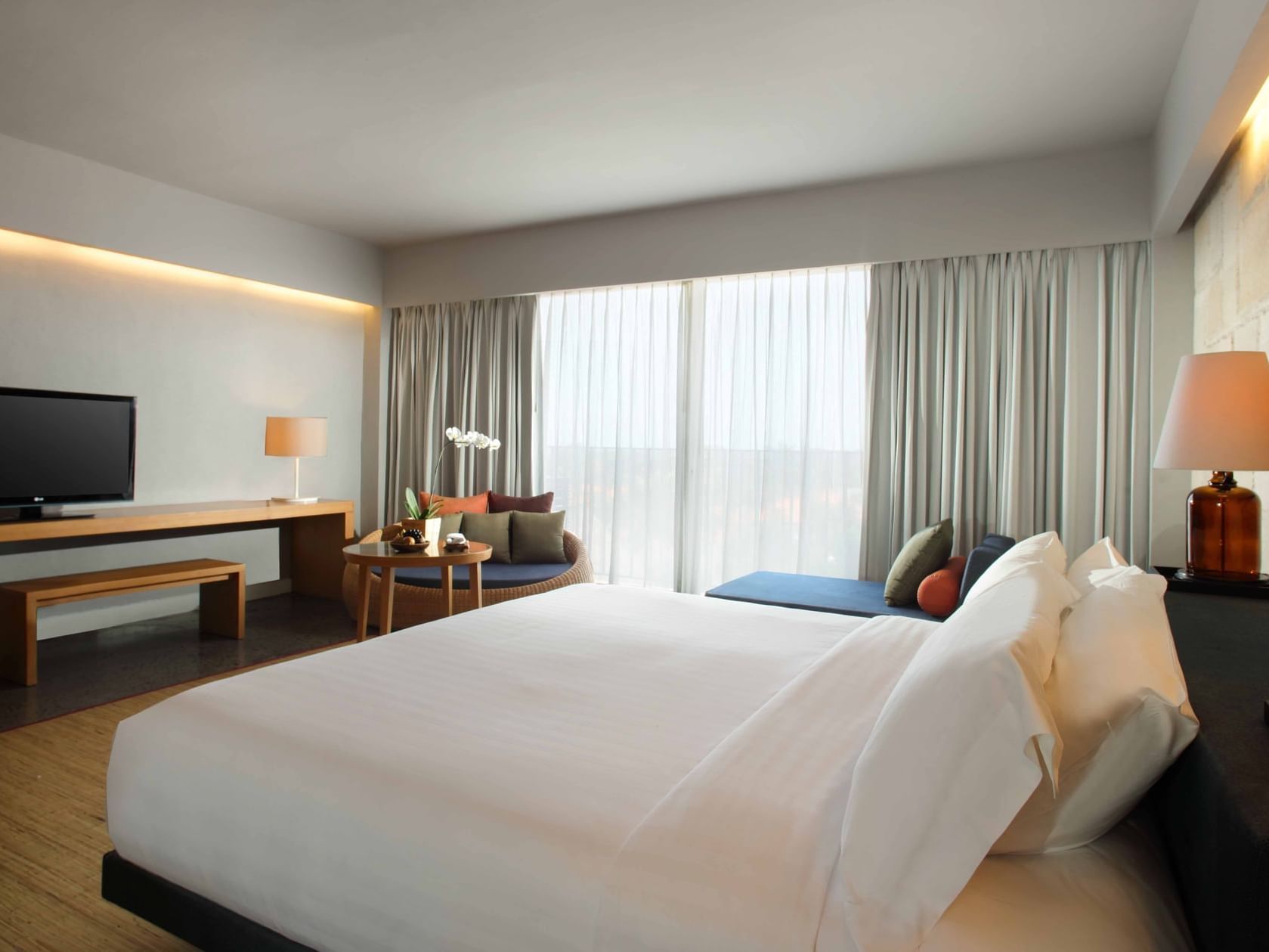 Bed with white beddings in Suites at U Hotels and Resorts